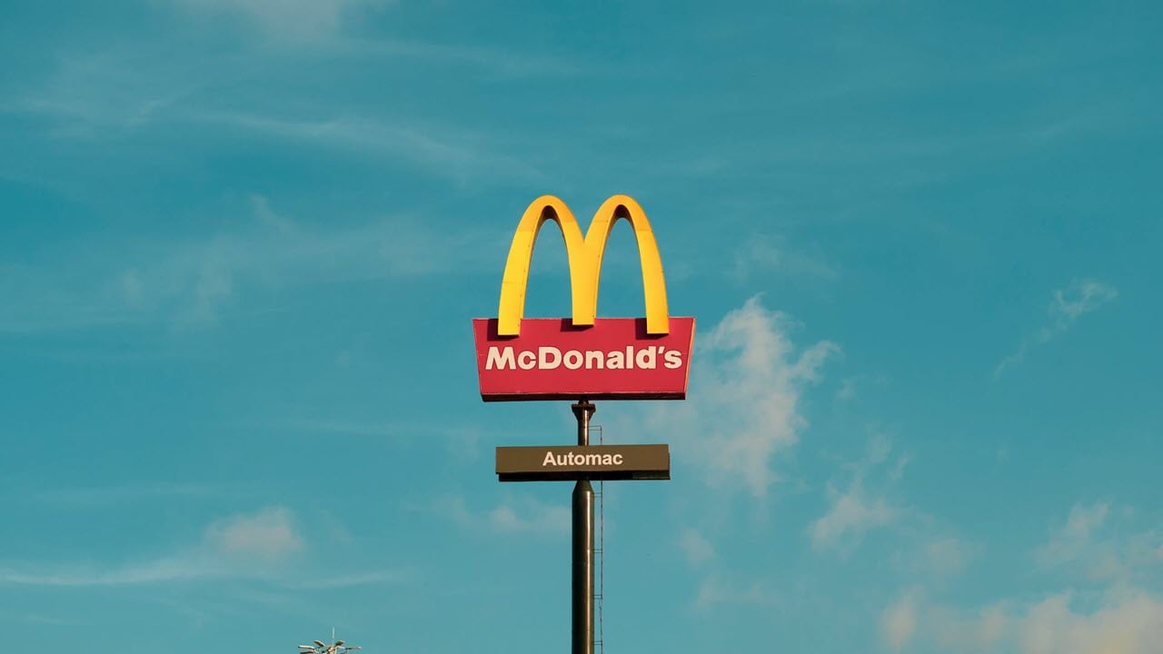 A mcdonald's sign on a pole.